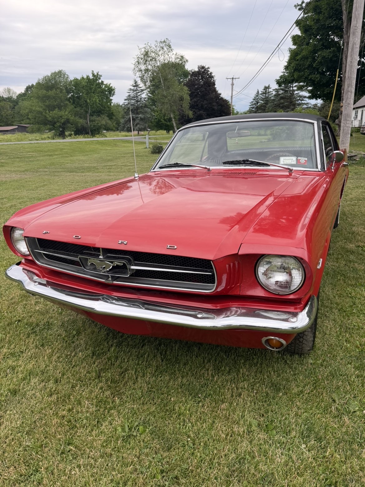 Same red Ford Mustang with deep glossy paint and polished chrome after detailing